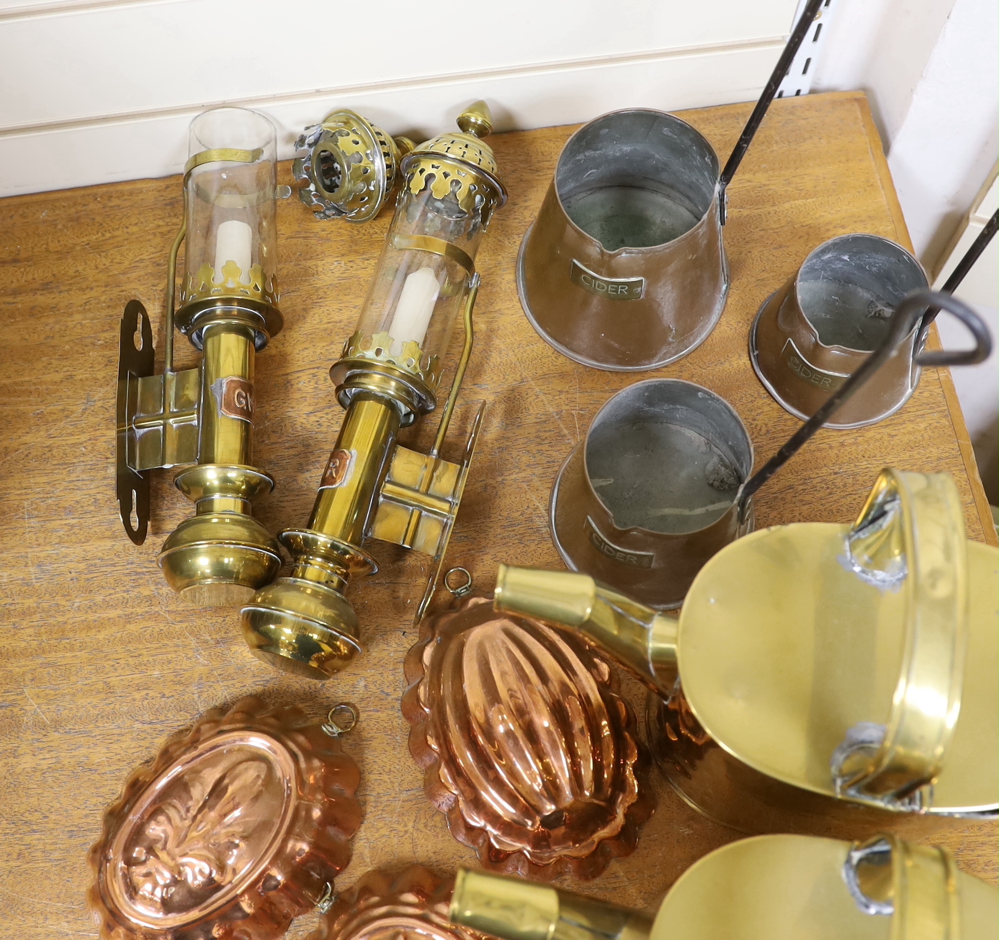 Two brass watering cans, two brass GWR carriage lamps, three copper Cider measures and three copper jelly moulds, GWR lights 36cm high